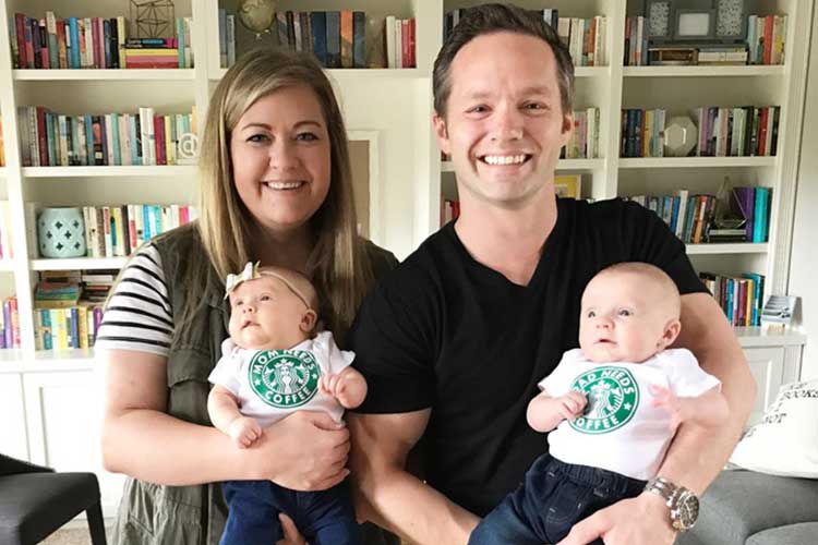Happy Couple Holding Twin Babies