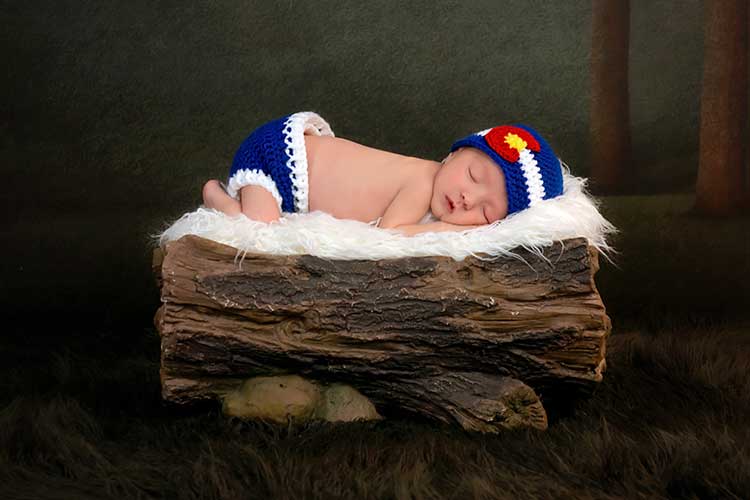 Newborn Baby Sleeping on a Piece of Wood