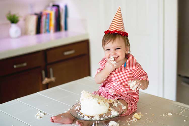 Baby Eating Birthday Cake on Counter