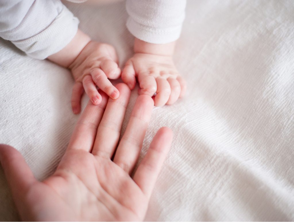 Baby holding mom's hand